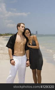 Close-up of a young couple standing on the beach