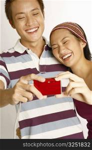Close-up of a young couple taking a picture of themselves