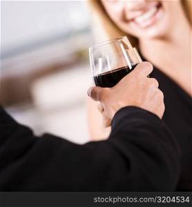 Close-up of a young couple toasting with glasses of wine