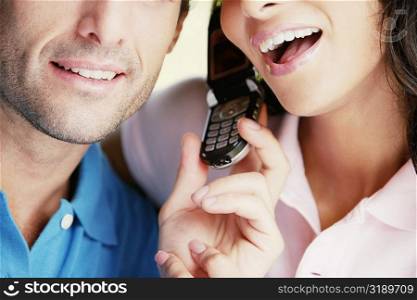 Close-up of a young couple using a mobile phone
