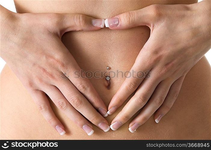 close up of a young female drawing an heart with hands on her stomach