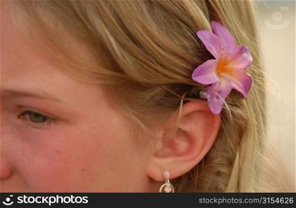 Close-up of a young girl (14-15) wearing a flower behind her ear, Moorea, Tahiti, French Polynesia, South Pacific