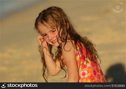 Close-up of a young girl (6-8) on a beach, Moorea, Tahiti, French Polynesia, South Pacific
