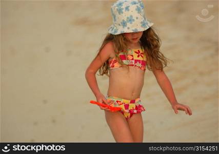 Close-up of a young girl (6-8), on a beach, Moorea, Tahiti, French Polynesia, South Pacific