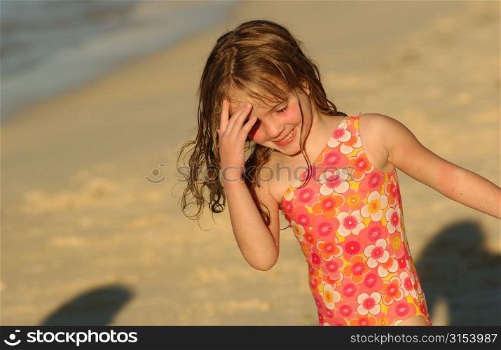 Close-up of a young girl (6-8) playing on a beach, Moorea, Tahiti, French Polynesia, South Pacific