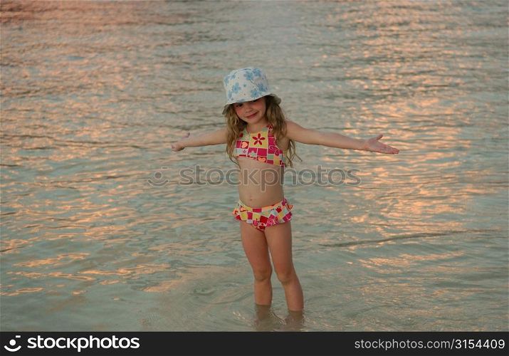 Close-up of a young girl (6-8) standing in water, Moorea, Tahiti, French Polynesia, South Pacific