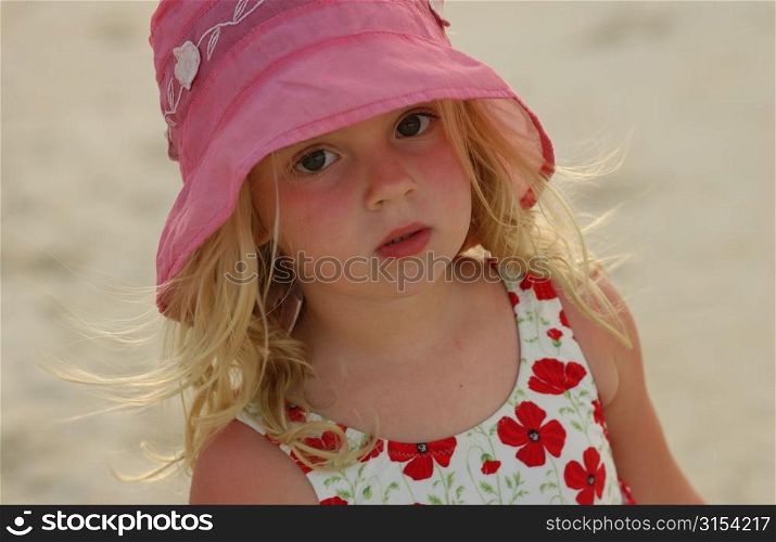Close-up of a young girl (6-8 wearing a sun hat, Moorea, Tahiti, French Polynesia, South Pacific