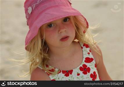 Close-up of a young girl (6-8 wearing a sun hat, Moorea, Tahiti, French Polynesia, South Pacific