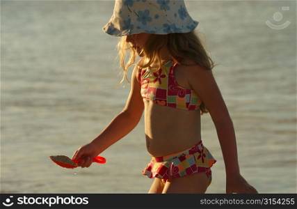 Close-up of a young girl on a beach, Moorea, Tahiti, French Polynesia, South Pacific