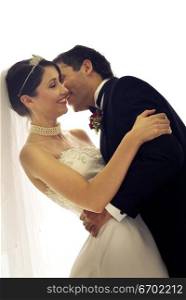 Close-up of a young groom kissing his bride