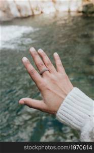 Close up of a young hand over the ocean with a rubber ring