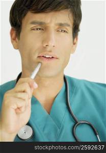 Close-up of a young male doctor thinking