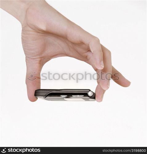 Close-up of a young man&acute;s hand holding a mobile phone