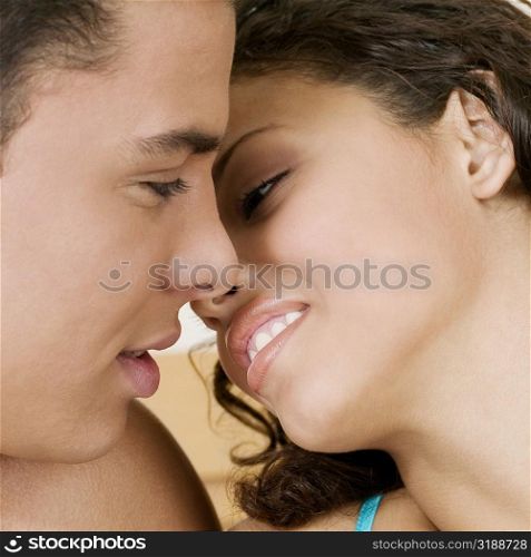 Close-up of a young man and a teenage girl facing each other