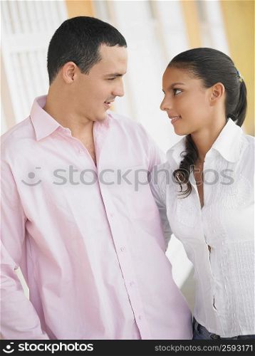 Close-up of a young man and a teenage girl looking at each other