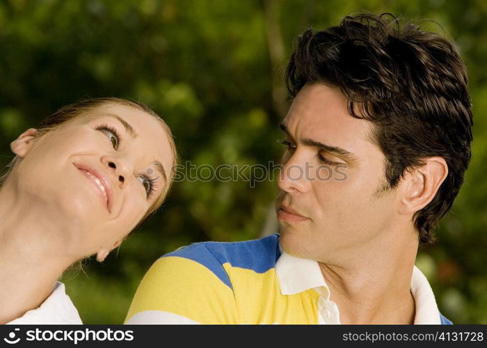 Close-up of a young man and a teenage girl looking at each other