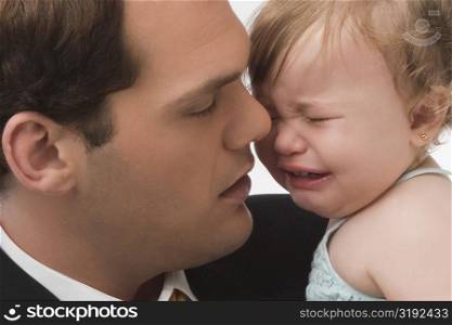 Close-up of a young man consoling his daughter