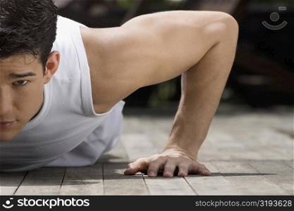 Close-up of a young man doing push-ups