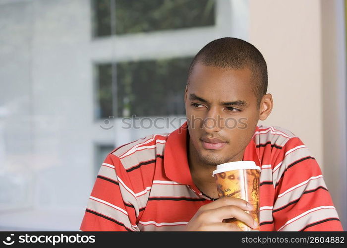 Close-up of a young man drinking coffee