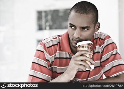 Close-up of a young man drinking coffee