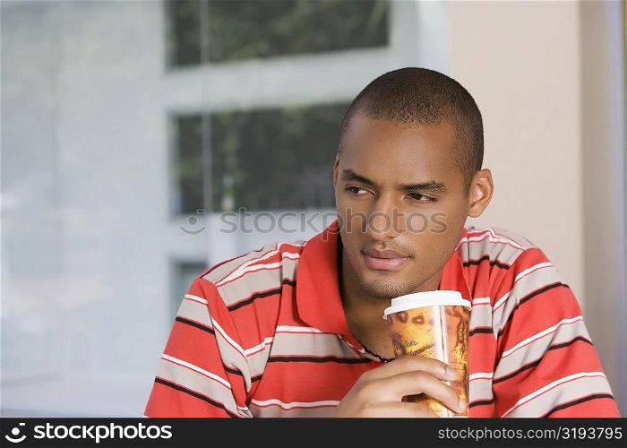 Close-up of a young man drinking coffee