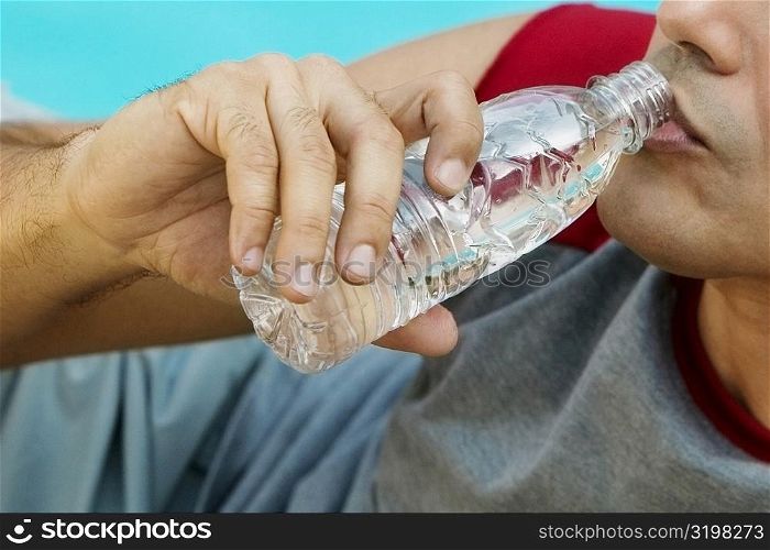 Close-up of a young man drinking water