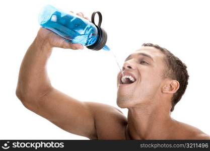 Close-up of a young man drinking water from a bottle