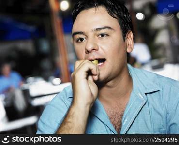 Close-up of a young man eating French fries