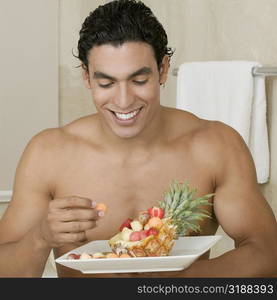 Close-up of a young man eating fruits