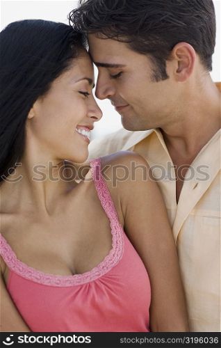 Close-up of a young man embracing a young woman