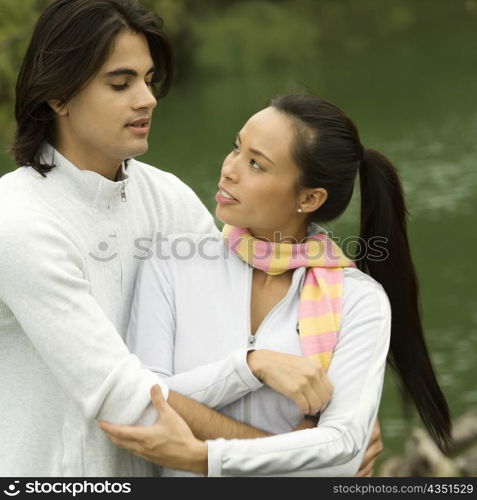 Close-up of a young man embracing a young woman