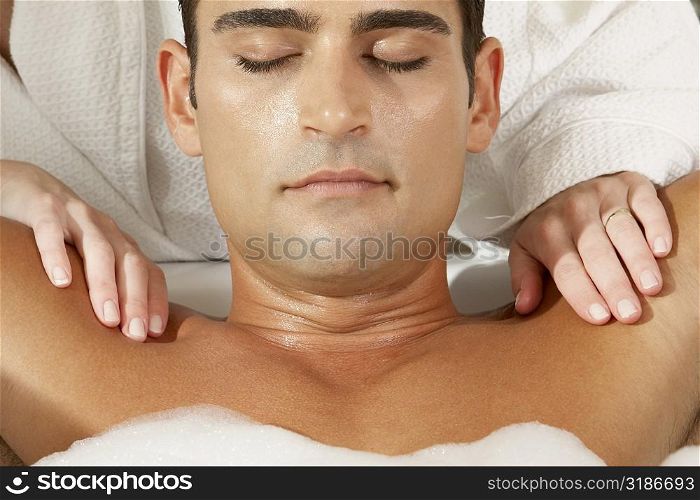 Close-up of a young man getting a massage from a massage therapist