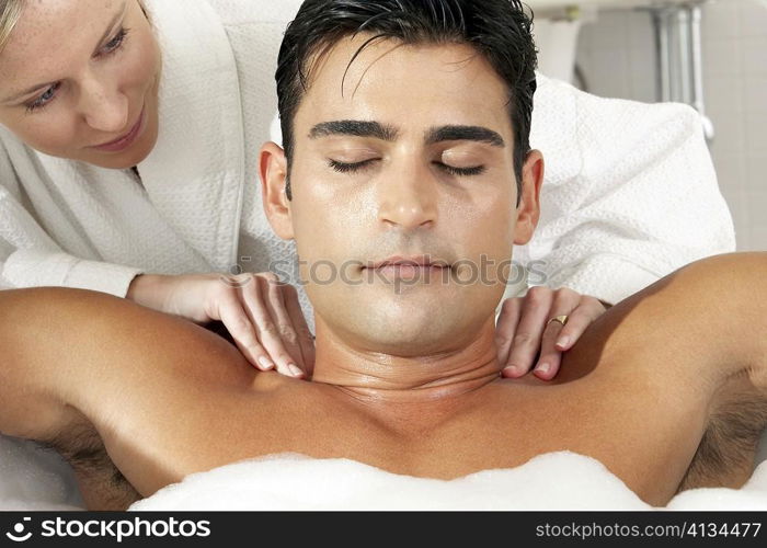 Close-up of a young man getting a massage from a massage therapist