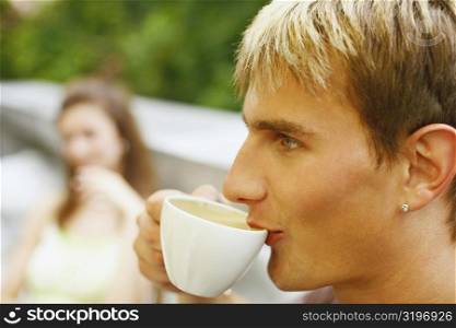 Close-up of a young man having a cup of tea