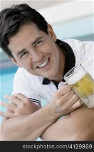 Close-up of a young man holding a beer glass