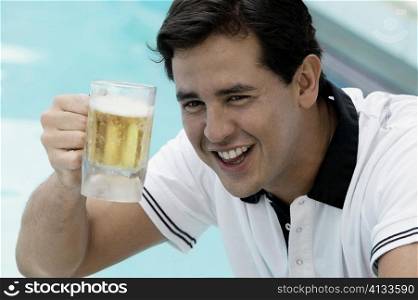 Close-up of a young man holding a beer glass