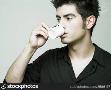 Close-up of a young man holding a cup of tea