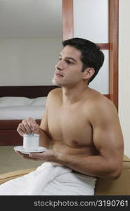 Close-up of a young man holding a cup of tea