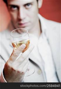 Close-up of a young man holding a glass of wine