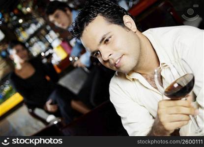 Close-up of a young man holding a glass of wine