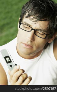 Close-up of a young man holding a mobile phone