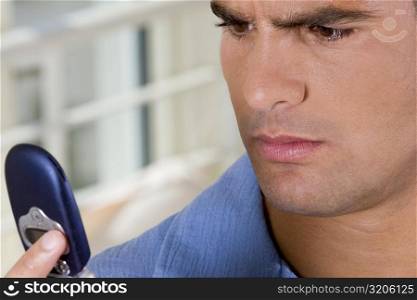 Close-up of a young man holding a mobile phone