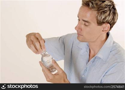 Close-up of a young man holding a water bottle