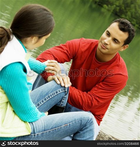 Close-up of a young man holding a young woman&acute;s hand