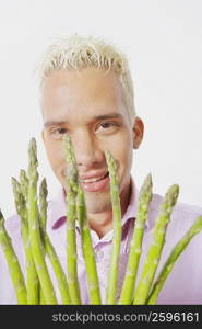 Close-up of a young man holding asparagus