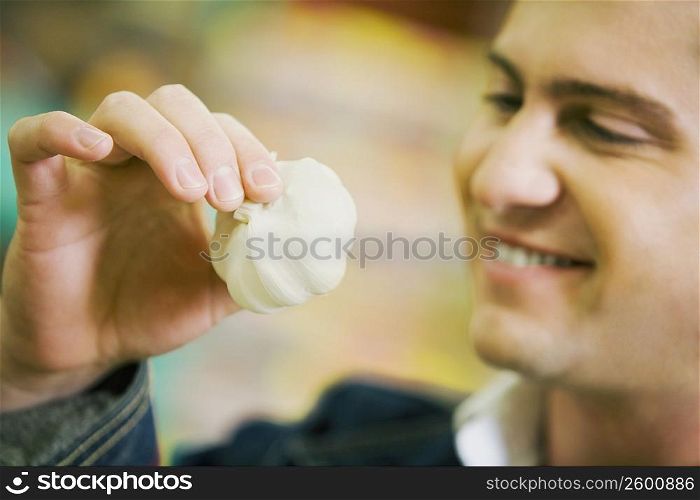 Close-up of a young man holding garlic