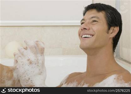 Close-up of a young man in a bubble bath