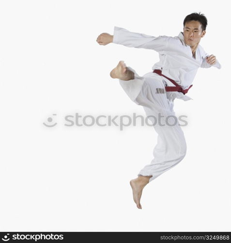 Close-up of a young man jumping and practicing martial arts