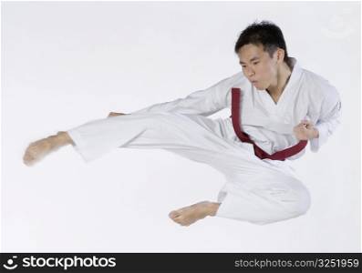 Close-up of a young man jumping and practicing martial arts
