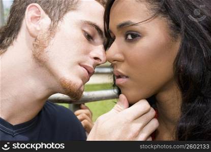 Close-up of a young man kissing a teenage girl